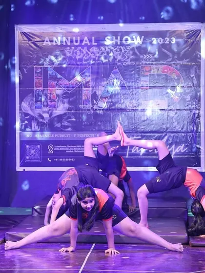 This intricate formation showcases incredible flexibility and strength. Our students perform advanced moves like splits and backbends as part of a cohesive and artistic group routine.