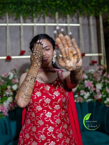 A playful pose from the bride, showing off both the front and back of her intricate henna design.