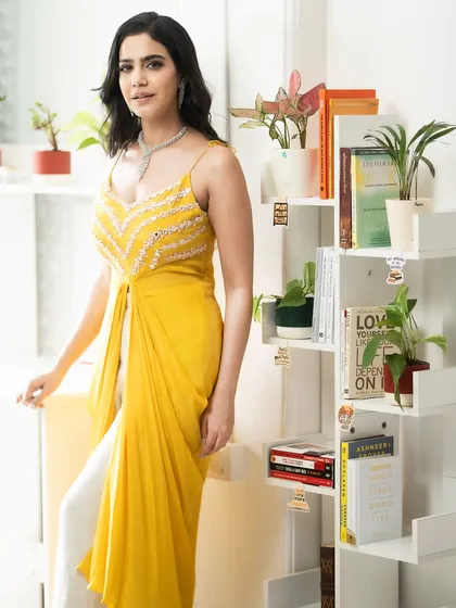 My work isn't just about lehengas. I love bringing my energy to chic Indo-Western outfits like this vibrant yellow ensemble. It shows my versatility and ability to model for brands that offer modern, festive fashion.