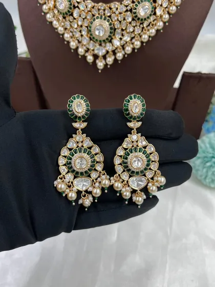 A close-up of the earrings from the green 'Zarista' set.