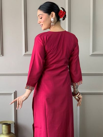 A gorgeous rani pink viscose chanderi kurta with a stunning floral printed dupatta. The heavy embroidery on the neckline makes it perfect for a festive occasion.