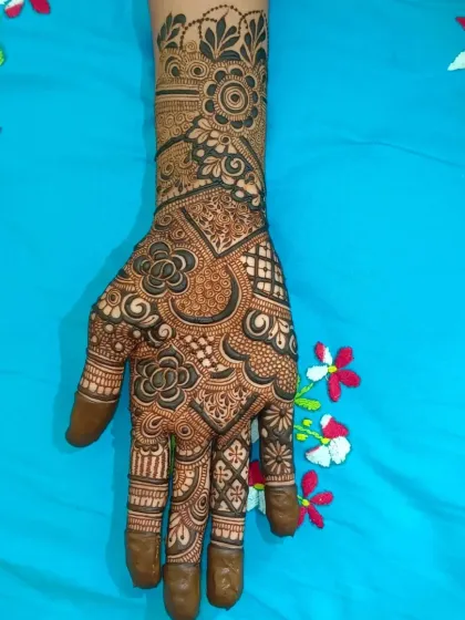 A full view of the completed semi bridal henna. The design is a mix of floral and geometric elements, creating a balanced and beautiful look.