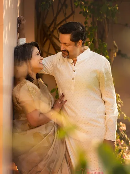 A romantic portrait of a couple celebrating their 25th anniversary. The warm, golden light of the outdoors adds a touch of magic to their special moment.