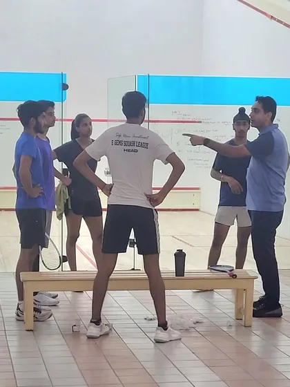 High-performance training sessions involve tactical discussions and on-court application. We use whiteboards to break down strategies and then immediately drill those patterns on the court.