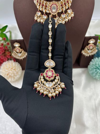 This collection showcases our premium Moissanite Kundan necklaces like the 'Noor Nazaakat' and 'Darbaar' sets. Each comes with a full set of earrings and maang tikka, available in various color combinations.