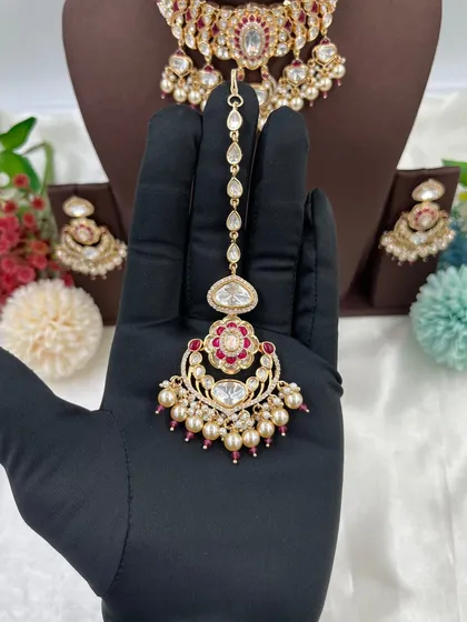 The 'Darbaar' maang tikka in red.
