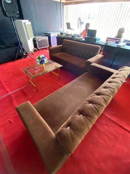 A comfortable lounge seating area being set up within a real estate exhibition. Providing these informal zones with sofas and coffee tables is a great way to facilitate longer conversations with potential clients in a relaxed setting.