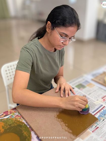 Before the stringing begins, the board is prepped and painted. This participant is applying a base coat for her sunflower art.