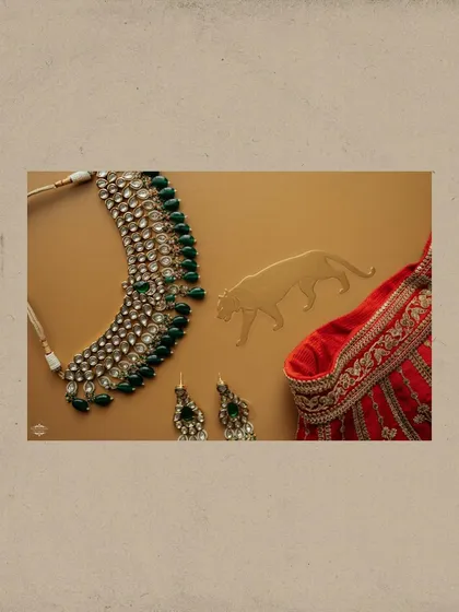 The details matter. This flat lay showcases the bride's stunning Sabyasachi jewelry and a piece of her lehenga, highlighting the craftsmanship and personal style that make each wedding unique.