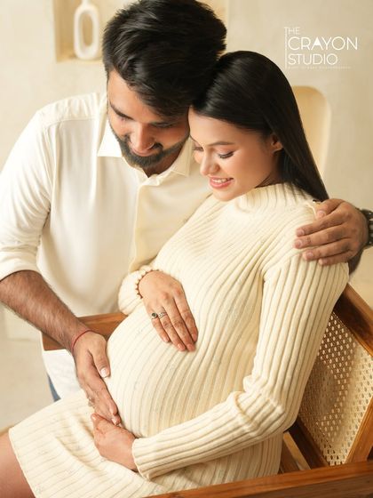 A beautiful moment between the couple as they both look down at the baby bump. This is a classic pose that is always full of love and meaning.