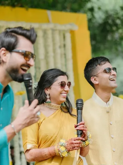 Sharing the mic with the happy couple during their Haldi. I love involving the bride and groom in the games and making them the center of the fun.