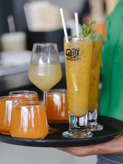 A tray of fresh juices ready to be delivered to a table. Staying hydrated and refreshed is easy here.