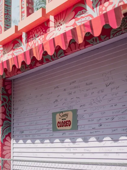 A "Sorry we're closed" sign on a custom-built stall, covered in handwritten notes from guests. We love creating interactive elements that become cherished keepsakes from the celebration.