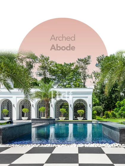 Titled 'Arched Abode,' this design fuses modern architecture with classical elements. The pristine white arches frame the tranquil pool area, creating a space thoughtfully designed for relaxation and well-being.