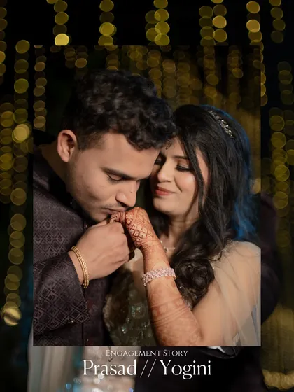 A classic engagement portrait, with the groom tenderly kissing his fiancée's hand against a backdrop of sparkling lights. This shot is all about romance.