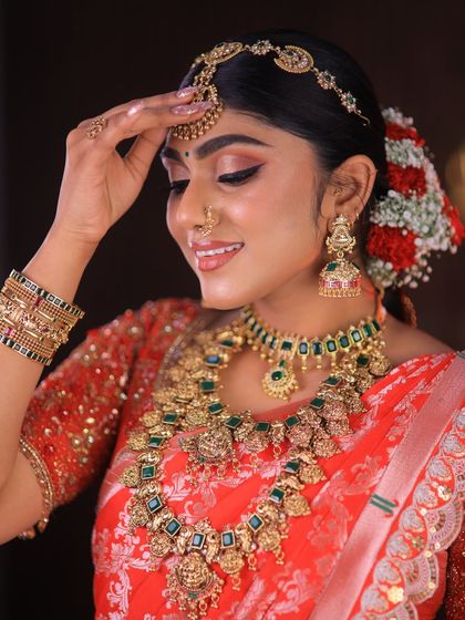 This stunning red floral saree is styled for a high-fashion bridal shoot. The drape is immaculate, designed to look dramatic and beautiful on camera.