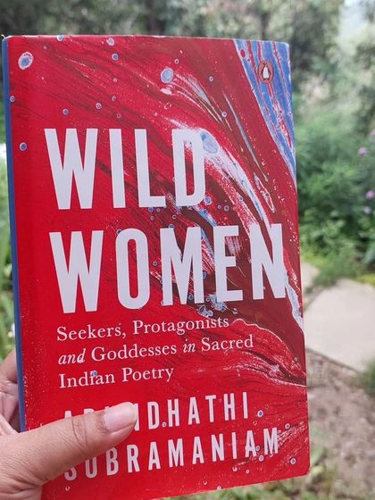 A participant holding Arundhathi Subramaniam's "Wild Women." Reading the work of our mentors is a key part of the immersive experience.
