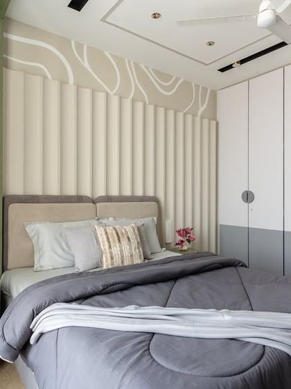 This bedroom is a harmonious blend of soft structure and modern minimalism. The ribbed wall panels and wave-inspired ceiling design create a visual rhythm, offering a calming backdrop for rest and rejuvenation.