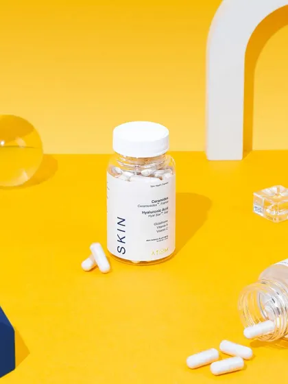 A playful, abstract setup for a skin supplement. We used colorful geometric props and scattered capsules to create a fun and engaging composition that highlights the product in a clean, studio environment.