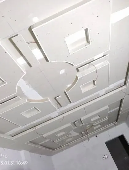 A large, complex geometric POP ceiling design covering an entire room, showcasing a high level of precision and planning.