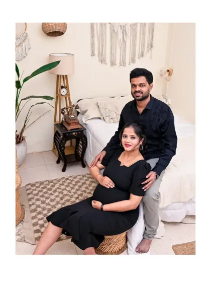 A comfortable and relaxed couple's portrait in our Boho bedroom set. The natural tones and textures of the rug, chair, and wall decor create a cozy and inviting scene for this maternity photo.