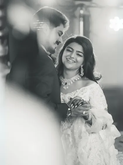 A classic black and white shot of the couple's first dance. This timeless style emphasizes the raw emotion and connection, stripping away distractions to focus purely on the moment of shared happiness.