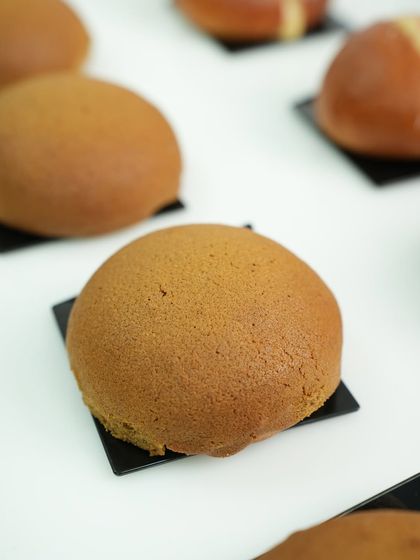 A perfectly baked PappaRoti-style coffee bun, with its signature crisp topping. This is a popular item in our international breads module.