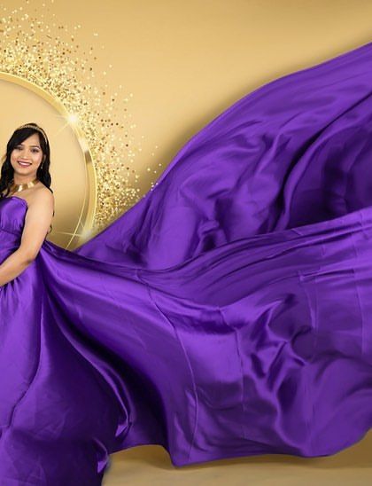 This vibrant purple satin gown creates a stunning visual with its expansive, flowing fabric. We use this technique to add motion and a sense of grandeur to our studio portraits.