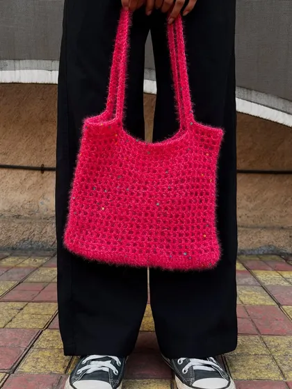 A custom order for a fuzzy pink tote bag. The textured yarn gives it a unique, almost fluffy appearance, and the little sparkles add a touch of glam.