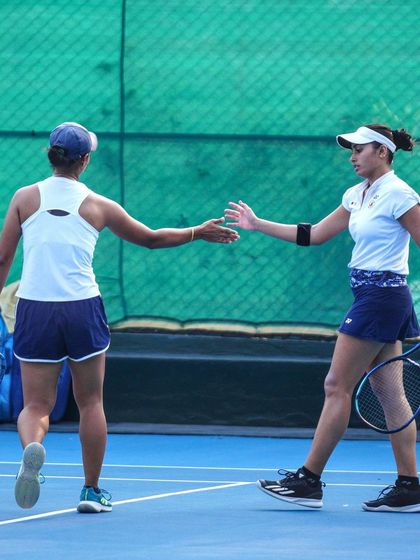 Another view of doubles partners showing sportsmanship and teamwork, a crucial element for success.