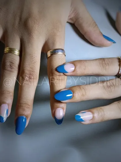 A still shot of the striking blue and negative space nail art.