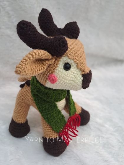 My crochet reindeer soft toy, complete with antlers and a festive green and red scarf.