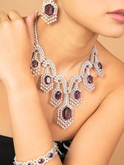 Another view of the amethyst and diamond necklace, showing how it drapes beautifully on the neckline. This piece is all about modern glamour and sophistication.