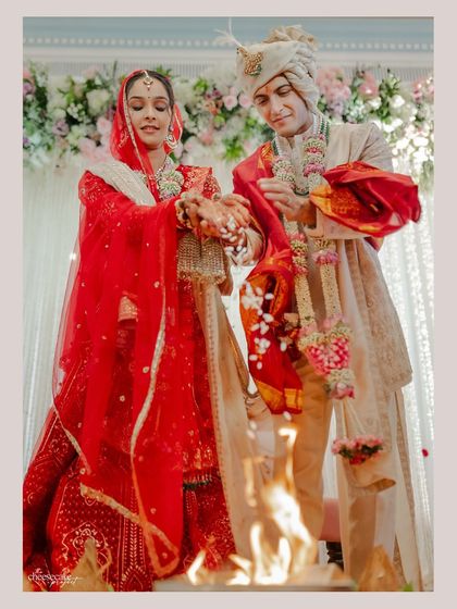 The couple performing the 'havan' ritual during their Pheras, a deeply spiritual and significant moment.