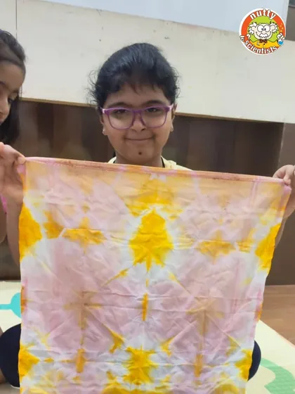 Look at that amazing pattern. By folding and tying the cloth in different ways, each child creates a unique design with natural vegetable dyes.