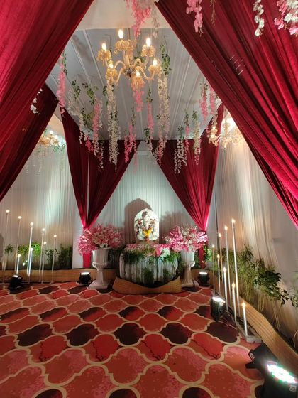 It's important to incorporate sacred elements beautifully. Within this entrance walkway, I created a special alcove for a Ganesh idol, decorated with pink flowers and soft lighting to offer a moment of peace and blessing.