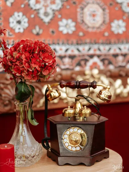 A vintage-style rotary telephone used as a decorative prop. This nostalgic detail added a touch of old-world charm to the heritage-themed 'Laal Ishq' wedding.