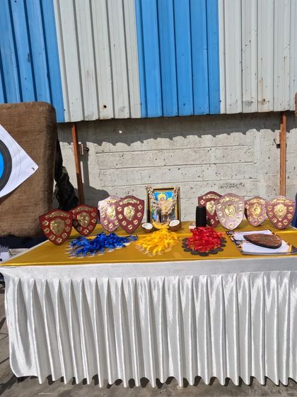 Getting the medals, shields, and blessings ready before a competition. We make every event special for our archers.