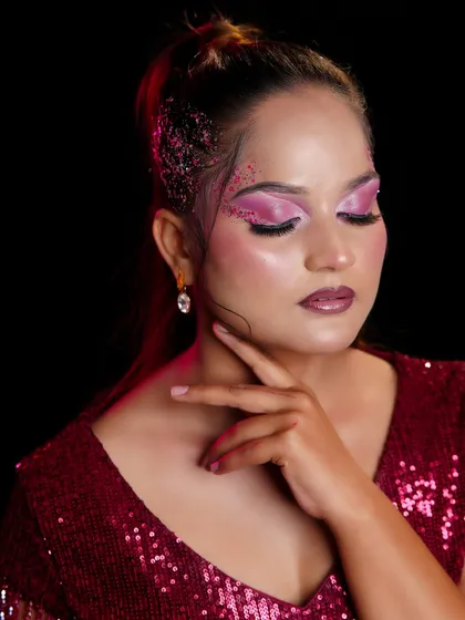 A close-up of the pink glitter eye makeup, showcasing the student's skill in creating a look that is both bold and beautiful.