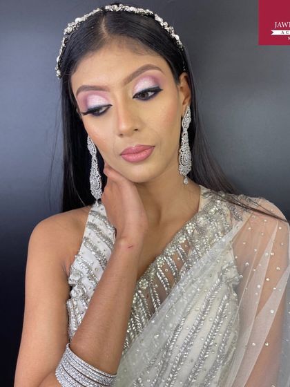 A beautiful silver cut-crease eye makeup look, paired with a glass skin base and glossy nude lips for a modern party style.