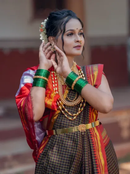 The model adjusting her jewellery, a candid moment captured during the portfolio shoot.