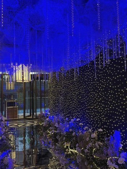 A view from further inside the celestial entrance tunnel, looking back towards the start. The design creates a truly immersive experience, making guests feel as if they are traveling through a galaxy to join the party.