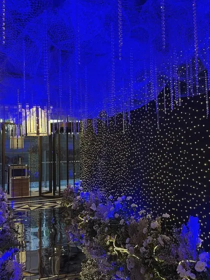 A view from further inside the celestial entrance tunnel, looking back towards the start. The design creates a truly immersive experience, making guests feel as if they are traveling through a galaxy to join the party.