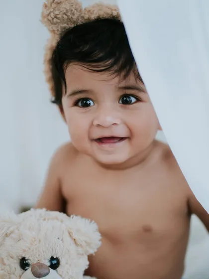 A happy grin from this little teddy bear. His personality is shining in this fun and candid shot.