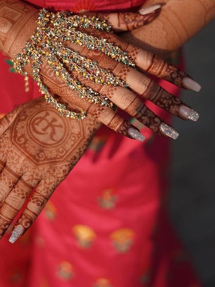 A detailed shot of the colourful crystal hand harness, perfectly complementing the henna design.