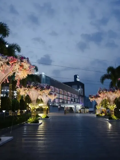 The arrival experience is paramount. Here, I designed large, illuminated floral structures to line the driveway of the hotel, creating a grand and welcoming pathway for an evening reception that begins the moment guests are on the property.