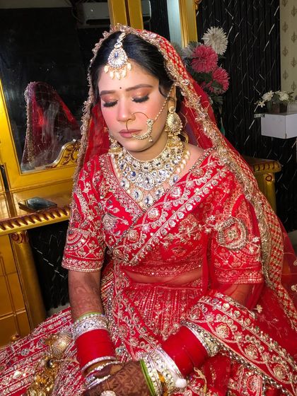 A moment of calm before the ceremony. The soft eye makeup and flawless base create a serene and beautiful bridal portrait.