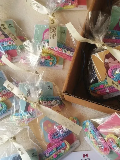 A box full of our name clips, individually wrapped with ribbons. This is a great option if you're looking for beautifully packaged and affordable return favors.