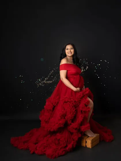 A little bit of sparkle to celebrate this magical time! For this shot, we added some glittery effects to the photo of this gorgeous mom-to-be in her dramatic red gown.