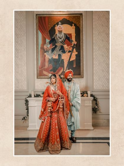 A classic portrait of the couple in front of a large, regal painting, adding an artistic and historical feel to their wedding photo.